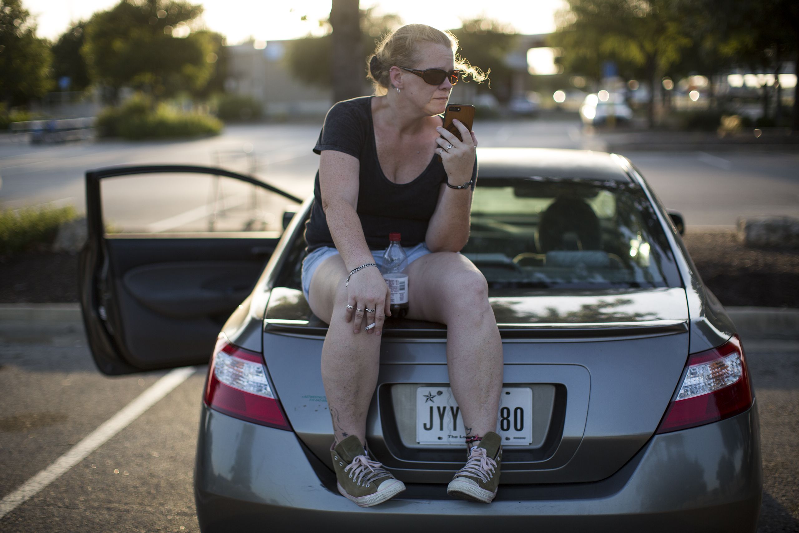 Karen Woodward speaks with her mother in a Walmart parking lot.